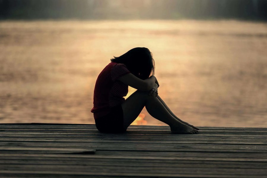 A person in quiet reflection outdoors